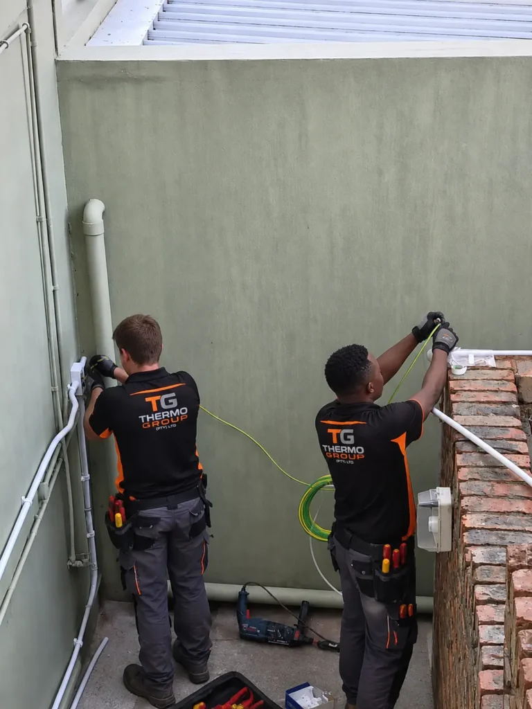 Thermo Group electricians running conduit and cabling during an electrical installation, Cape Town