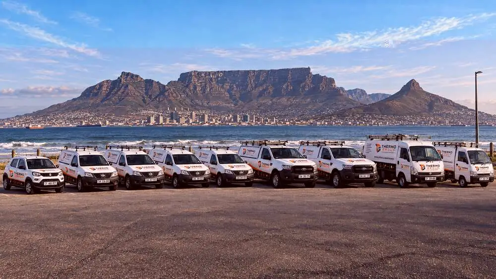 Thermo Group fleet of service vehicles parked with Table Mountain and Cape Town in the background