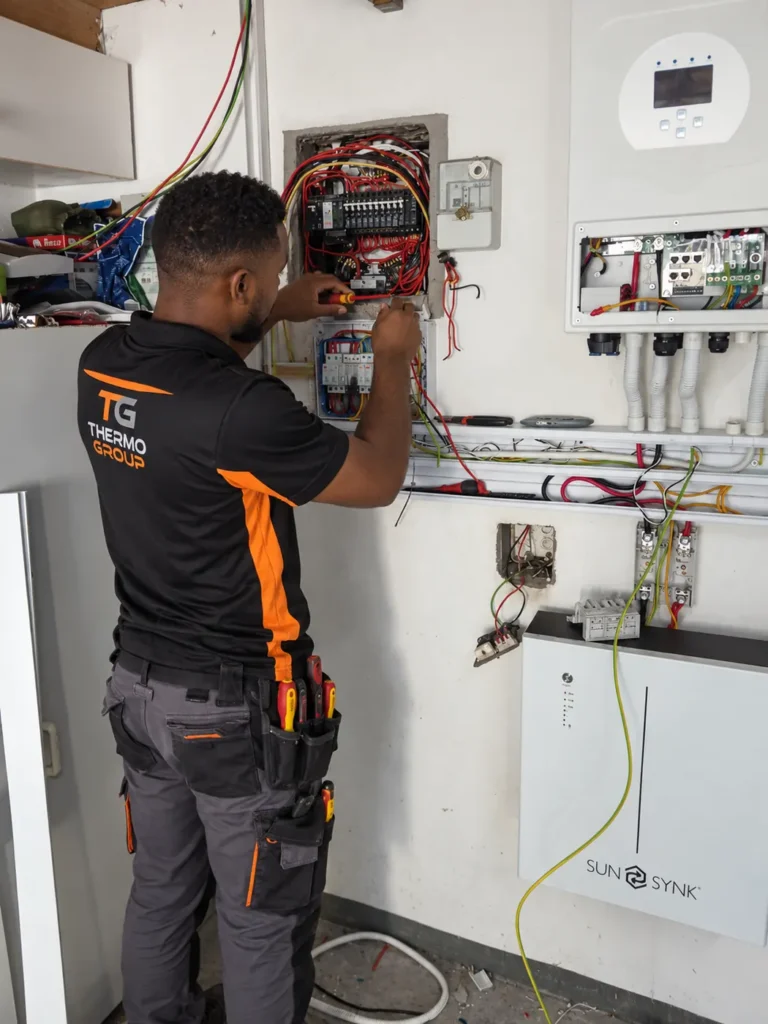 Thermo Group technician installing a SunSynk solar inverter and battery storage system