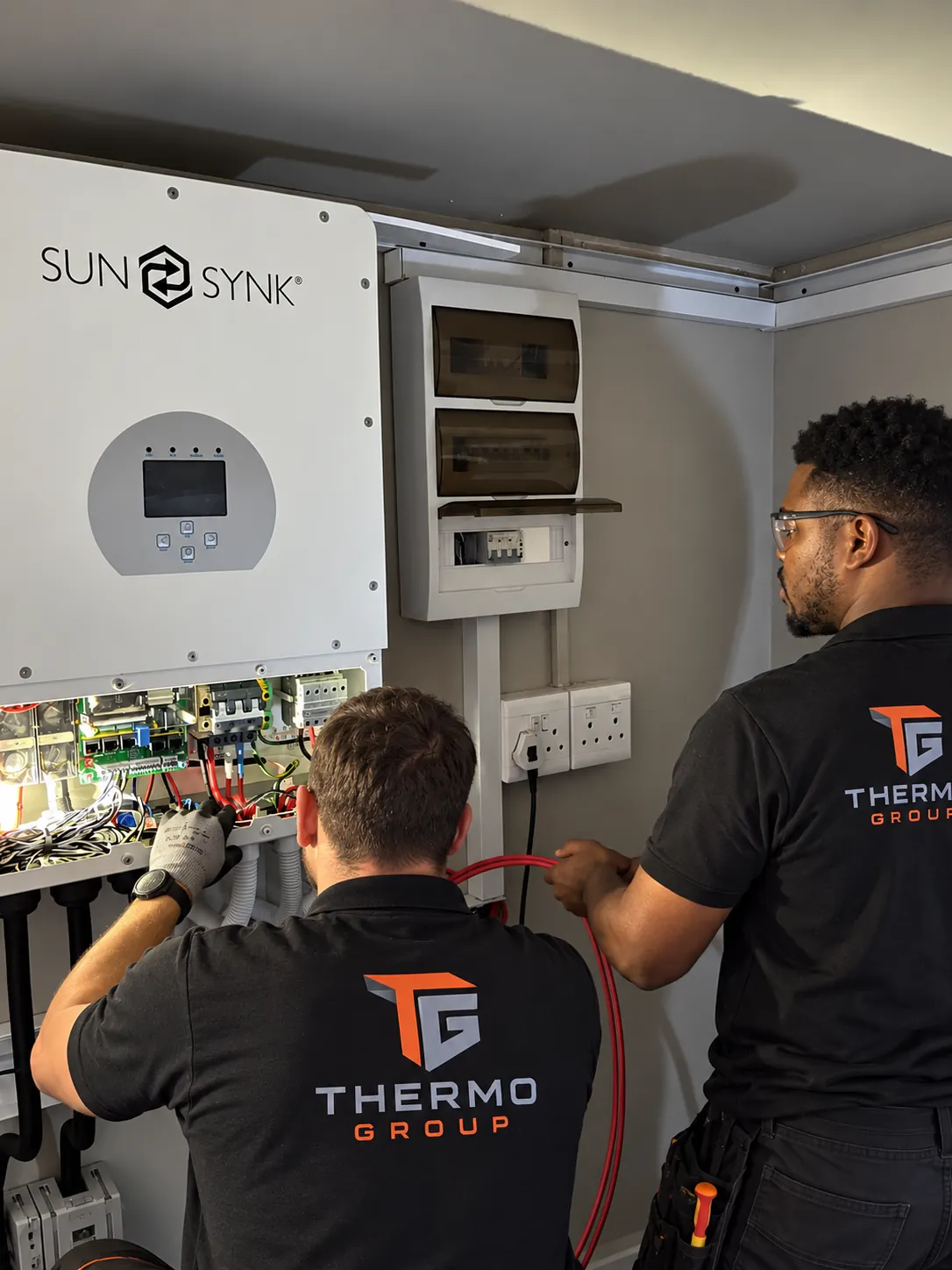 Thermo Group technician repairing a SunSynk solar inverter installation in Cape Town