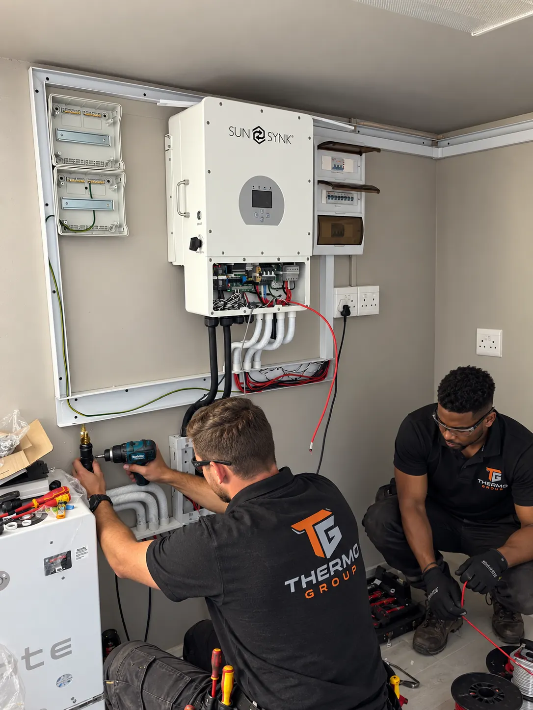 Thermo Group technicians installing a SunSynk inverter system in Constantia