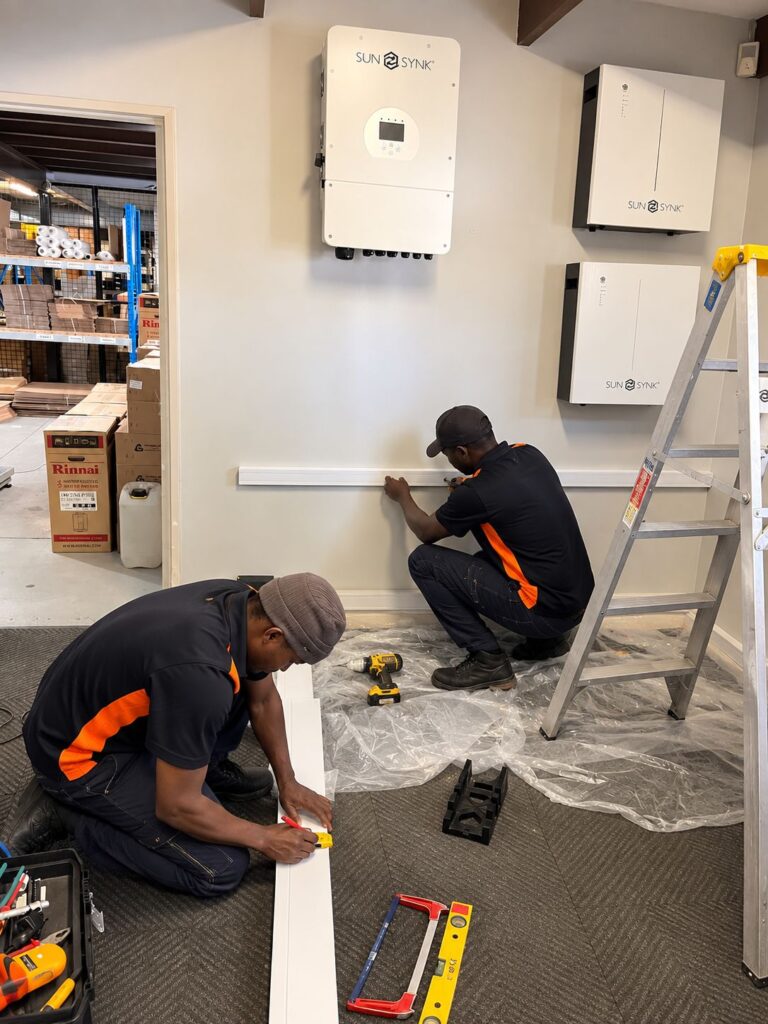 Thermo Group installers fitting trunking for a Sunsynk inverter and batteries