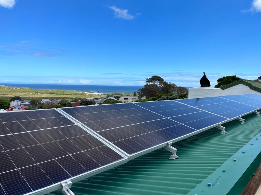 Solar panels on a green roof with ocean views near Cape Town
